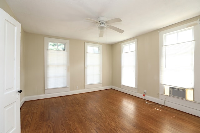 empty room with cooling unit, ceiling fan, and hardwood / wood-style floors