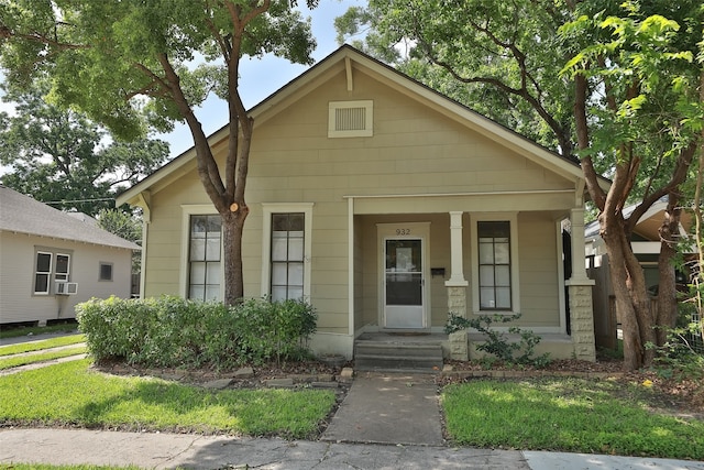 bungalow with a porch and cooling unit