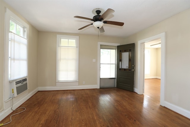 spare room featuring cooling unit, hardwood / wood-style floors, and ceiling fan