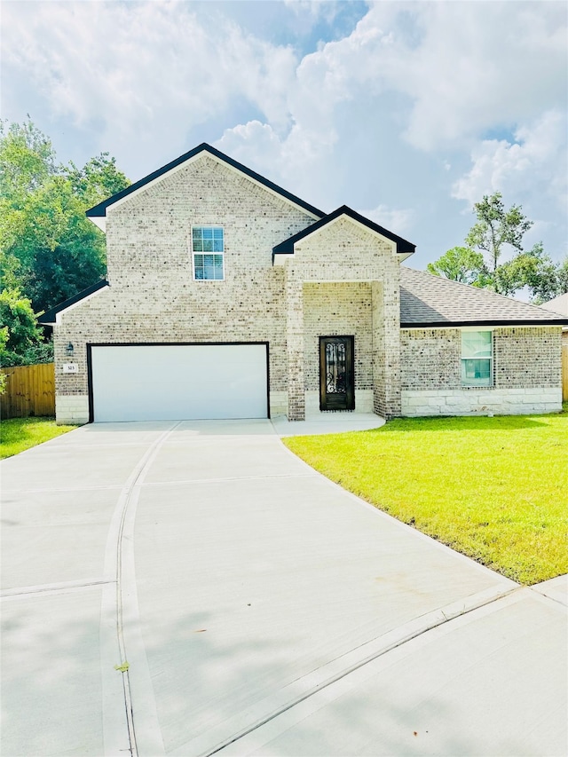 view of front of house featuring a garage and a front lawn