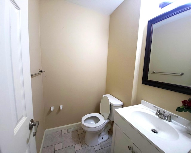 bathroom featuring tile patterned flooring, vanity, and toilet