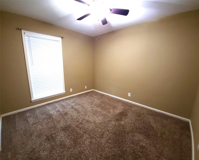 spare room featuring carpet and ceiling fan