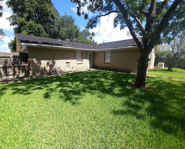 rear view of house with a lawn