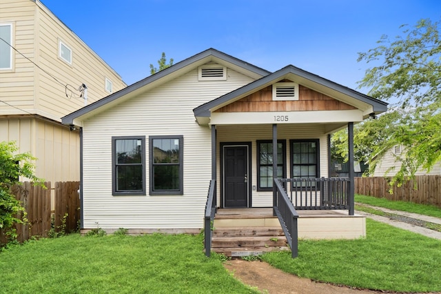 bungalow-style home with a porch and a front yard