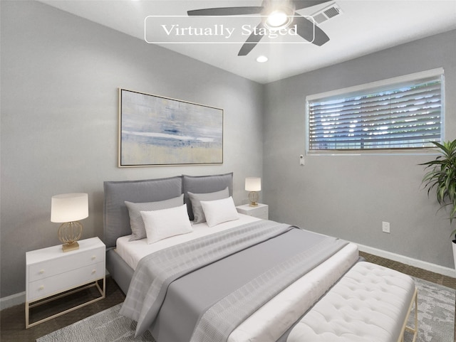 bedroom with dark colored carpet and ceiling fan