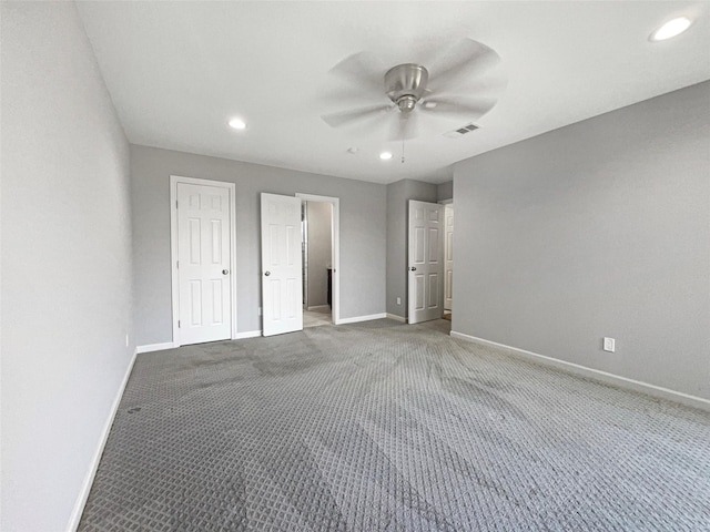 unfurnished bedroom featuring carpet and ceiling fan