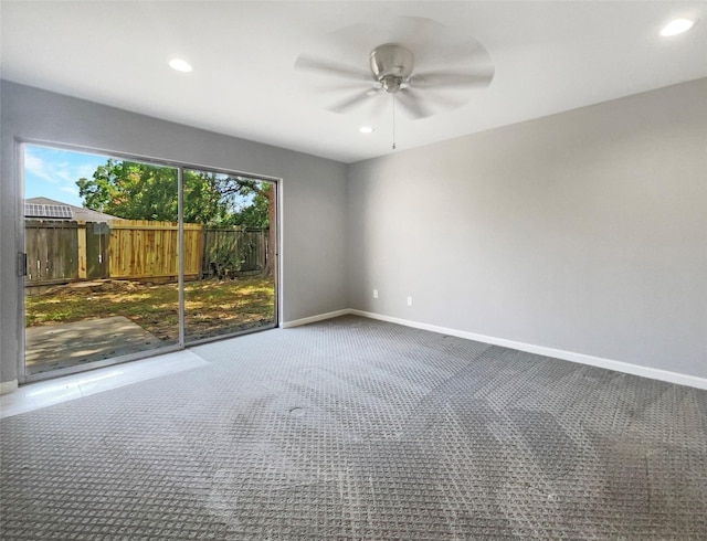 unfurnished room featuring ceiling fan and carpet