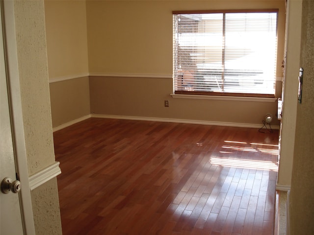 spare room featuring wood-type flooring