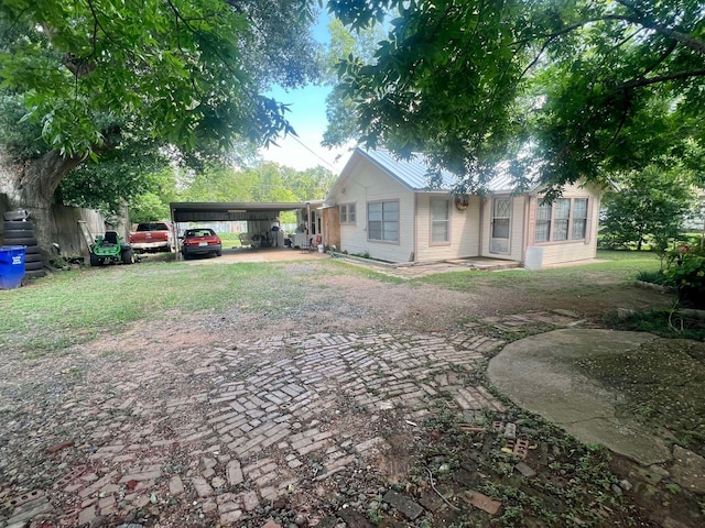 view of front of property with a carport and a front lawn