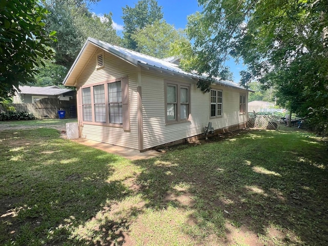 view of property exterior with a lawn