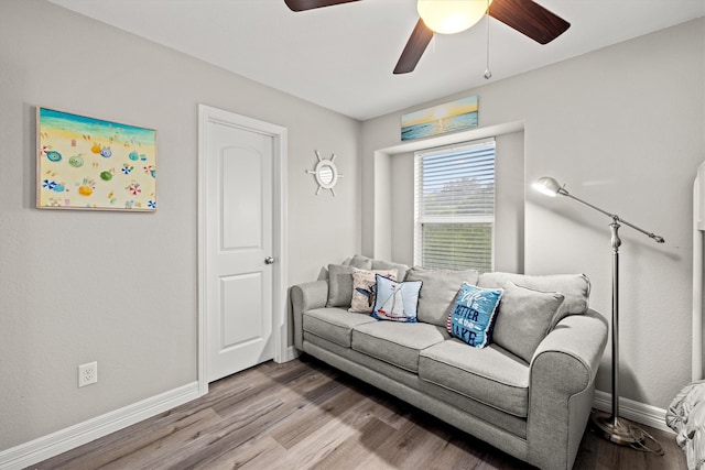 living room featuring hardwood / wood-style floors and ceiling fan