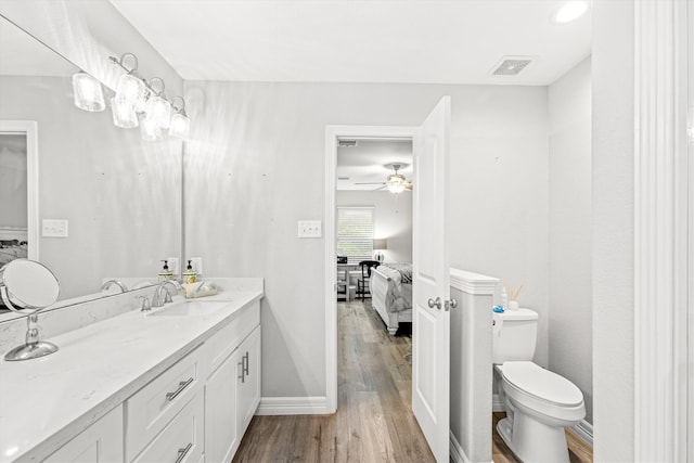 bathroom featuring vanity, ceiling fan, wood-type flooring, and toilet