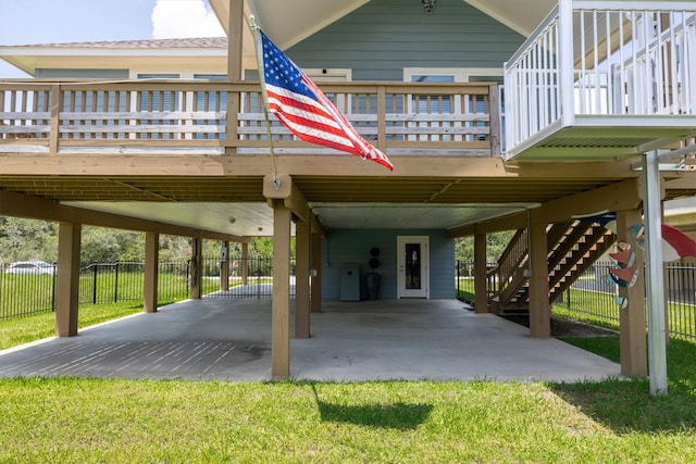 back of house with a deck, a carport, and a yard