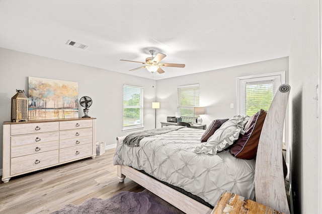 bedroom with light wood-type flooring and ceiling fan