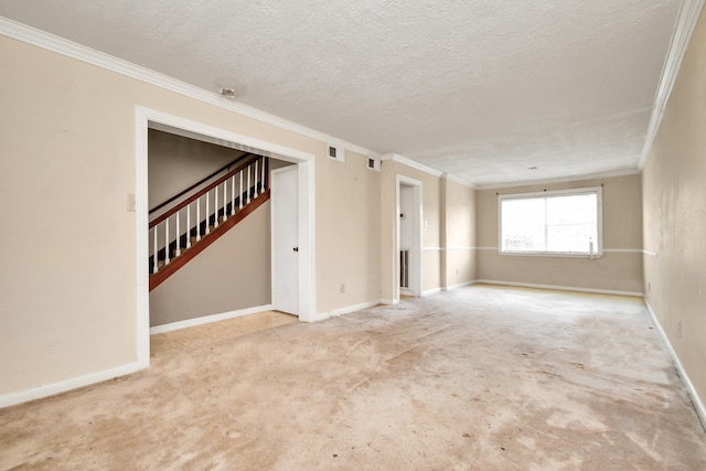 carpeted empty room with a textured ceiling and crown molding