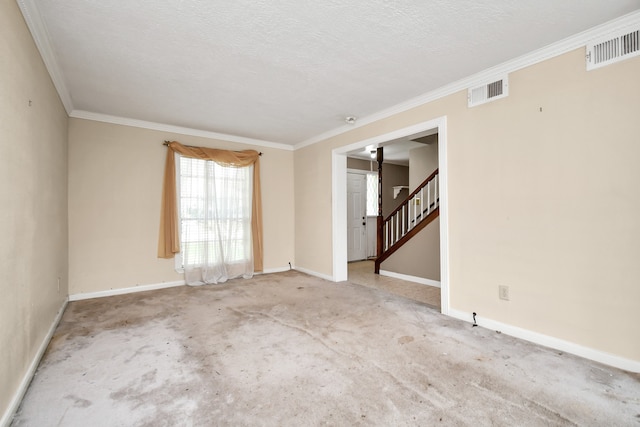 spare room with carpet floors, crown molding, and a textured ceiling