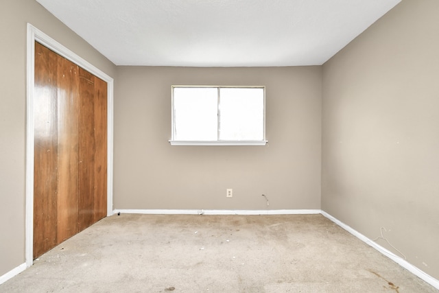 unfurnished bedroom featuring a closet and carpet