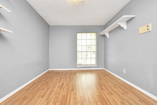 unfurnished room featuring light hardwood / wood-style floors