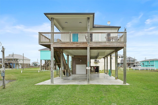 back of house featuring a wooden deck and a yard