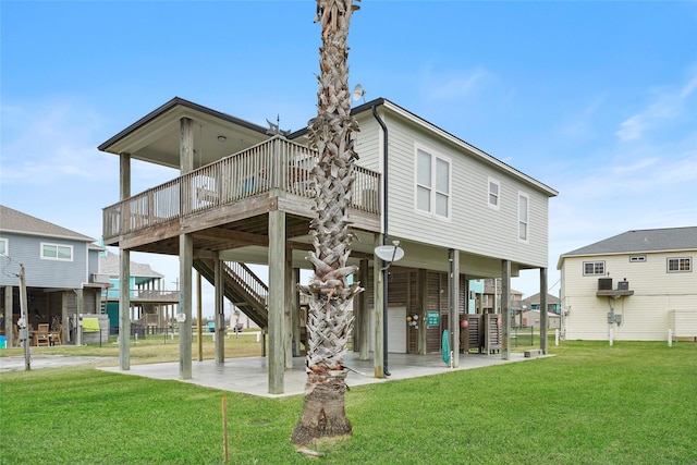 962 Driftwood Dr, Crystal Beach, TX 77650 - back of property with stairs and a yard