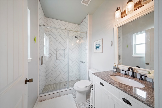 bathroom with vanity, toilet, tile patterned flooring, and walk in shower