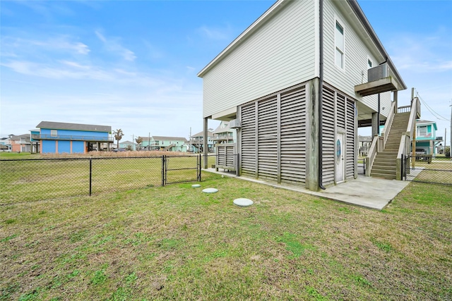 962 Driftwood Dr, Crystal Beach, TX 77650 - exterior space featuring stairs, a gate, fence, and a lawn