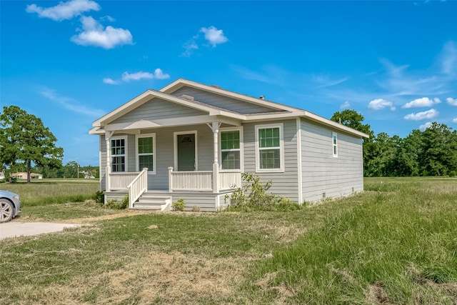 view of front of property with covered porch and a front lawn