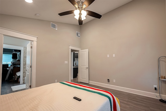 bedroom with dark wood-type flooring, high vaulted ceiling, and ceiling fan