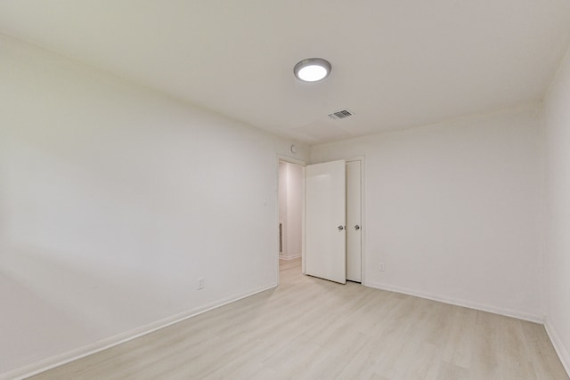 spare room featuring light hardwood / wood-style flooring