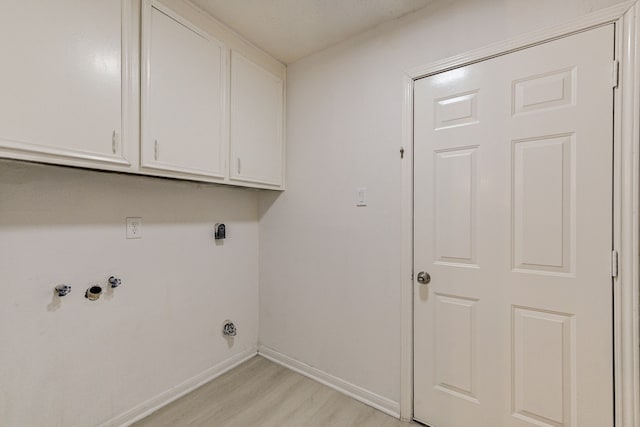 washroom with cabinets, light wood-type flooring, and electric dryer hookup