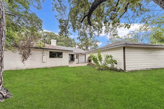 back of house with a yard