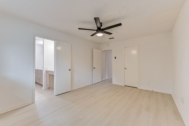 unfurnished bedroom with ceiling fan, light wood-type flooring, and ensuite bathroom