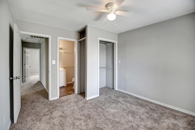 unfurnished bedroom with ceiling fan, light colored carpet, ensuite bathroom, and a closet