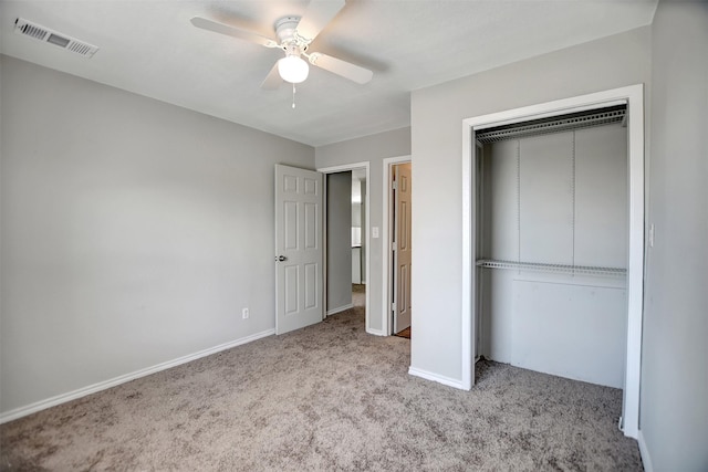 unfurnished bedroom with light colored carpet, ceiling fan, and a closet