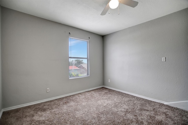 carpeted spare room with a textured ceiling and ceiling fan