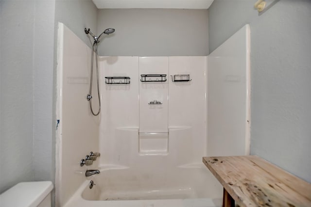 bathroom with shower / washtub combination and toilet