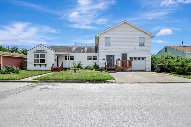 view of front of property featuring a garage and a front lawn