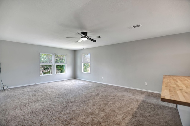 carpeted empty room featuring ceiling fan