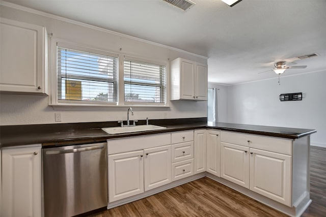 kitchen featuring sink, white cabinetry, stainless steel dishwasher, kitchen peninsula, and hardwood / wood-style floors