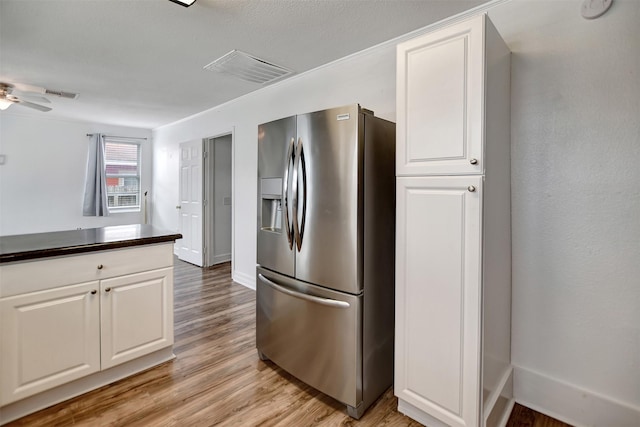 kitchen featuring white cabinetry, light wood-type flooring, ceiling fan, and stainless steel refrigerator with ice dispenser