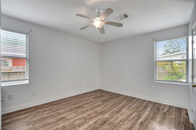 unfurnished room featuring hardwood / wood-style flooring and ceiling fan