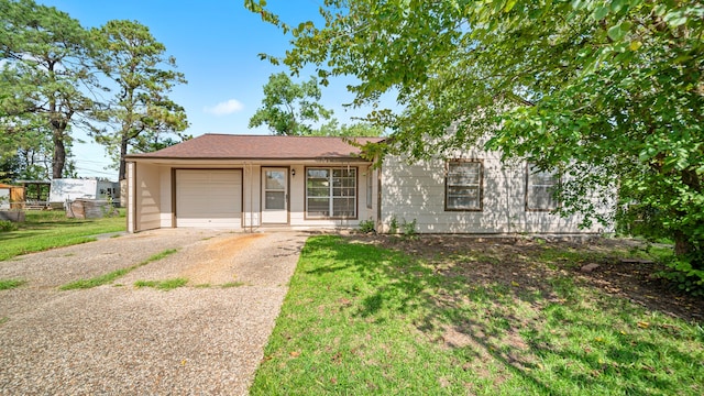 ranch-style home featuring a garage and a front yard