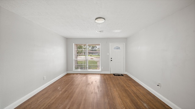 interior space featuring hardwood / wood-style flooring and a textured ceiling