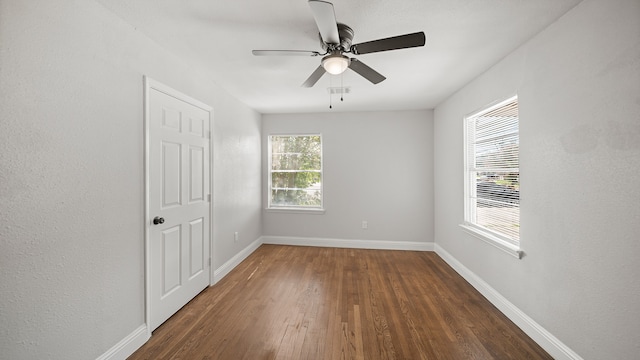 unfurnished room featuring dark hardwood / wood-style floors and ceiling fan