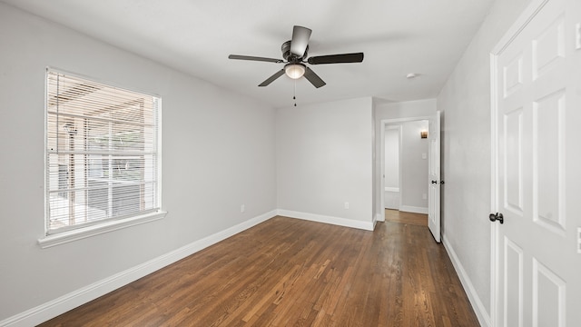 unfurnished bedroom featuring ceiling fan, dark wood-type flooring, and multiple windows