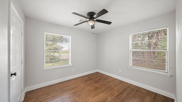 spare room featuring a healthy amount of sunlight, ceiling fan, and wood-type flooring