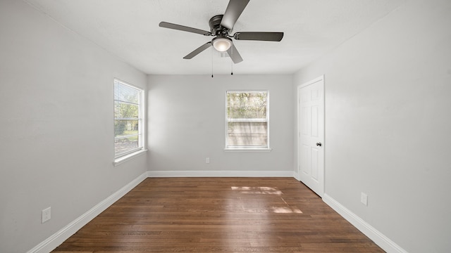 spare room with dark wood-type flooring and ceiling fan