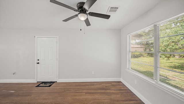 spare room featuring ceiling fan and dark hardwood / wood-style floors