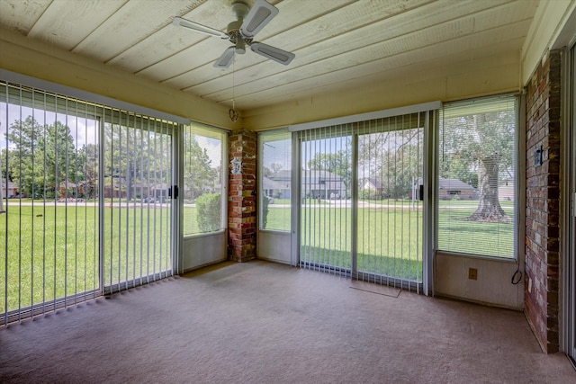 unfurnished sunroom with ceiling fan