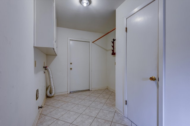 washroom with light tile patterned flooring and cabinets